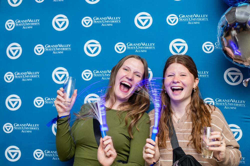 Two grads celebrating.